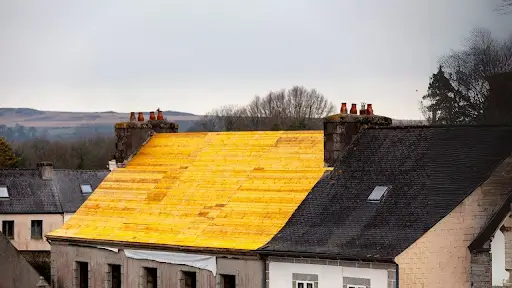 Roof under renovation with yellow materials.